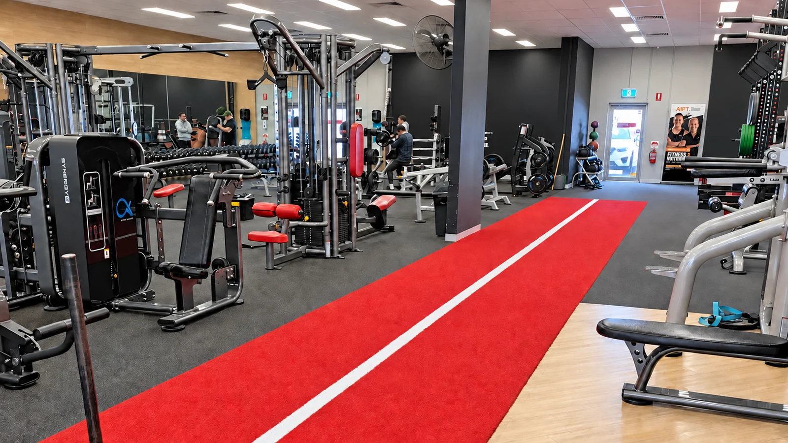 Strength equipment beside the red training track at Top Gym Knoxfield