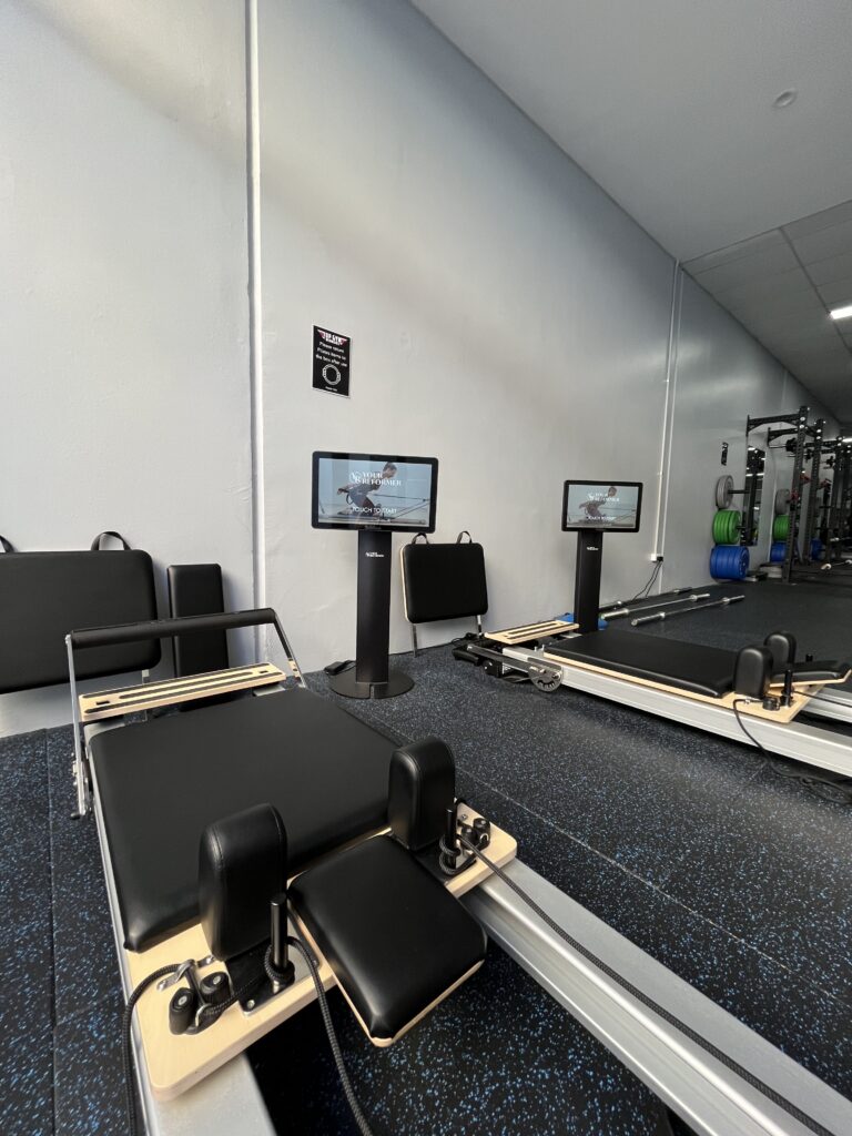 Reformer Pilates beds with individual workout kiosks at Top Gym Women’s Coburg