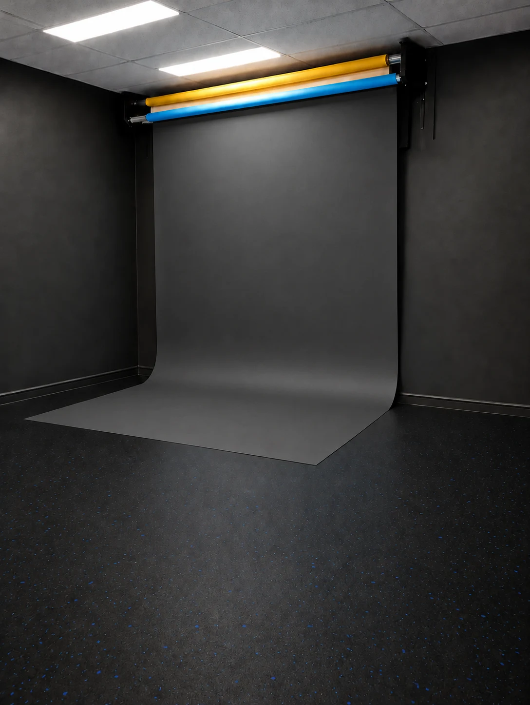 Black backdrop lowered in the studio — retouched visual preview