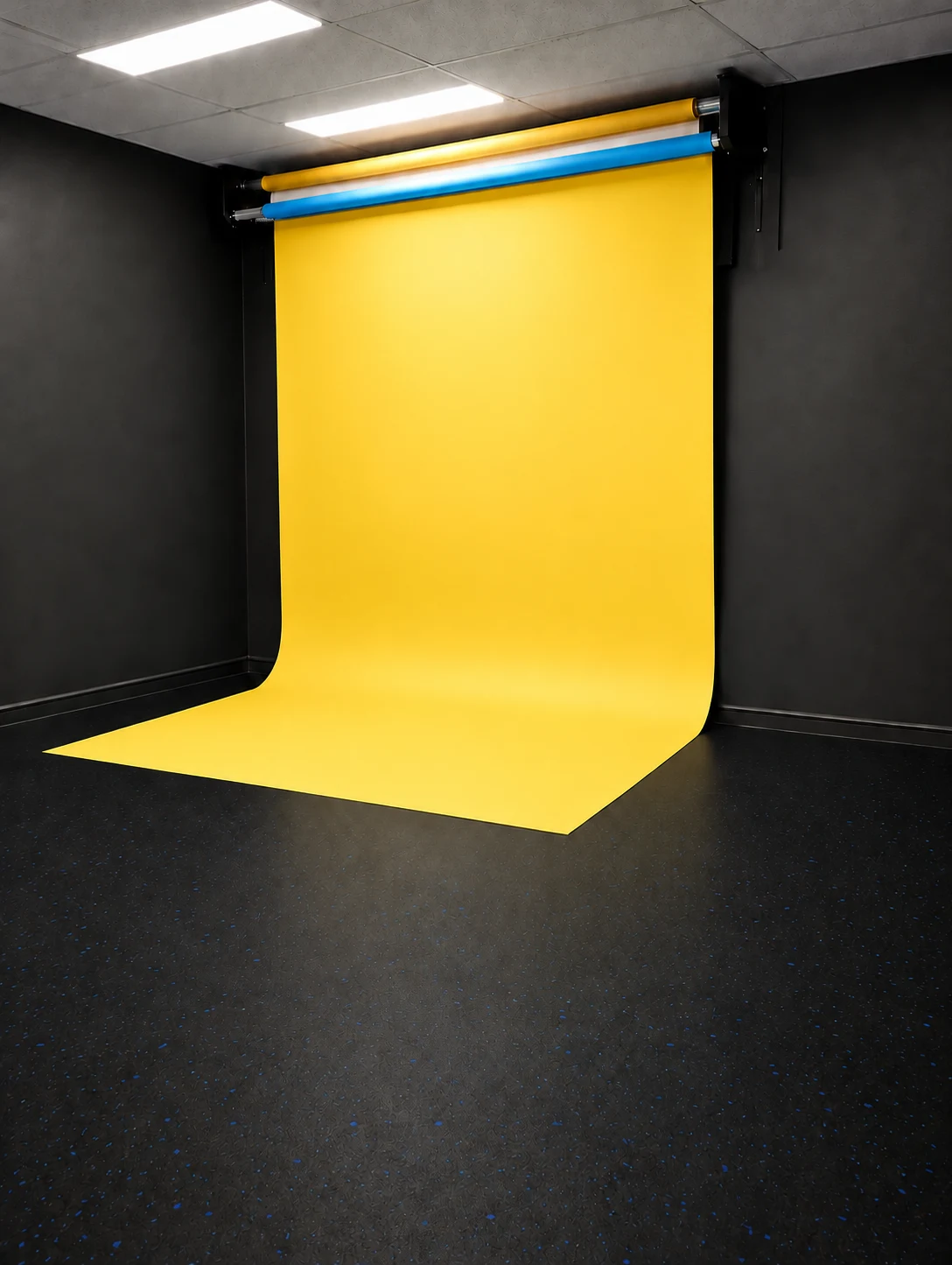 Yellow backdrop lowered in the studio — retouched visual preview