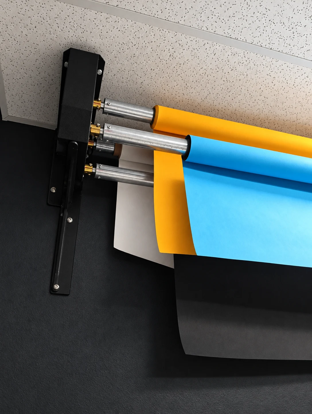 Blue, yellow, white and black studio backdrop rolls